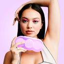 VUSH Aura Wireless Rechargable TENS Device with Travel Case held by a model with colorful eye makeup.