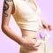 Person using the VUSH Aura Wireless Rechargable TENS Device with Travel Case on their abdomen.