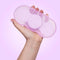 VUSH Aura Wireless Rechargable TENS Device with Travel Case held in hand, offering portable pain relief.