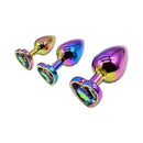 Adam & Eve Rainbow Heart Anal Plug Training Set featuring three graduated metal plugs with rainbow chrome and heart-shaped jewels.