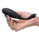 Whisperz Voice Activated 10x Vibrating Egg With Remote held in hand features sleek design for pleasure.