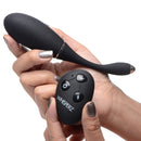 Whisperz Voice Activated 10x Vibrating Egg With Remote held in hand with remote control.