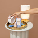 Playground Late Checkout Couples Intimacy Set with clock, lamp, and lubricants on a stylish table.