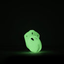 CB-X Glow-in-the-Dark Mini-Me Chastity Cage Kit glowing in the dark on a black background.