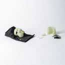 CB-X Glow-in-the-Dark Mini-Me Chastity Cage Kit with components on a black cloth background.