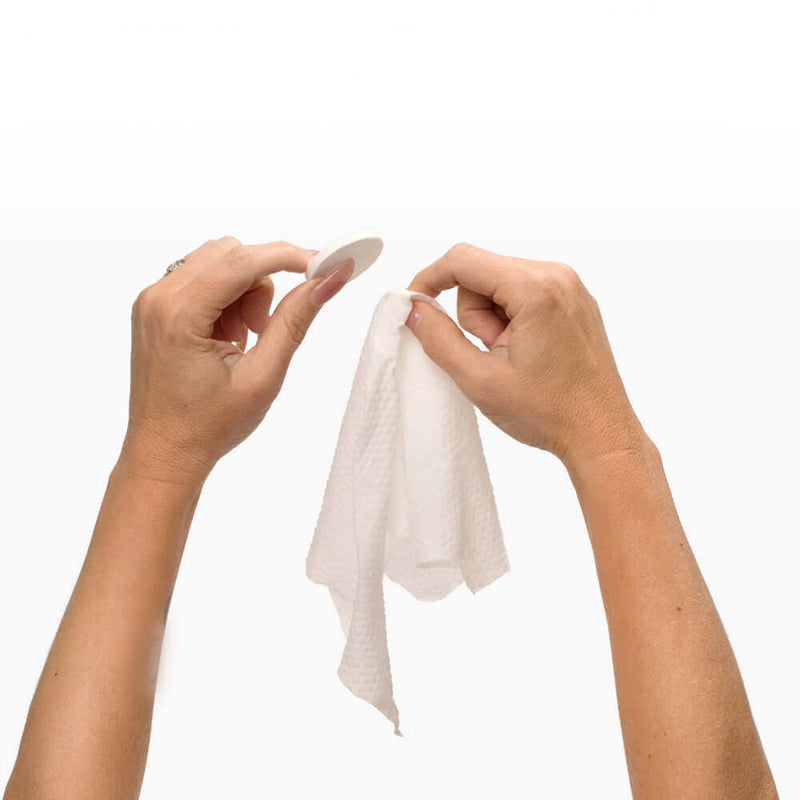 Hands demonstrating the usage of Beloved Pop-Up Cleansing Cloths for instant freshness.