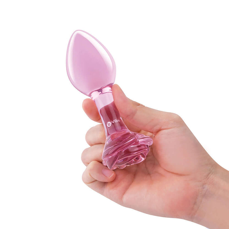 b-Vibe Pink Roses Training Plug Set held in hand, showcasing the elegant design and rose base.