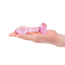 b-Vibe Pink Roses Training Plug Set held in a hand, showcasing elegant glass anal plug design.