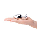 b-Vibe Jewel Metal Training Plug Set being held in a hand showcasing its sleek design and manageable size.
