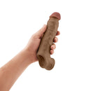 Shaft Vibrating Model F Penis Sheath Size 2 Oak held in hand, showcasing realistic texture and design.