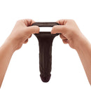 Shaft Vibrating Model F Penis Sheath Size 2 Mahogany being held in hands, showcasing its realistic design and flexibility.