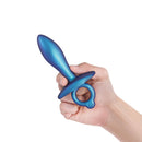 b-Vibe Butties Slide Silicone Butt Plug held in hand, showcasing its ergonomic design and sleek blue finish.