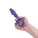 b-Vibe Butties Dart Silicone Anal Plug held in hand, showcasing its sleek and ergonomic design for beginner-friendly use.