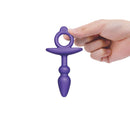 b-Vibe Butties Dart Silicone Anal Plug being held in a hand, showcasing its ergonomic design and playful shape.