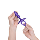 b-Vibe Butties Dart Silicone Anal Plug held by hands, showcasing its ergonomic design and smooth silicone finish.
