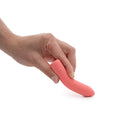 Hand holding the Je Joue Ily The Bullet Squishy Classic Vibrator, showcasing its compact design and soft texture.