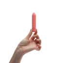 A hand holding the Je Joue Ily The Bullet Squishy Classic Vibrator, showcasing its soft, pink design.
