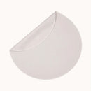 Dame Thro Waterproof Sex Blanket Oat folded in a circular shape, showcasing its smooth surface and soft material.