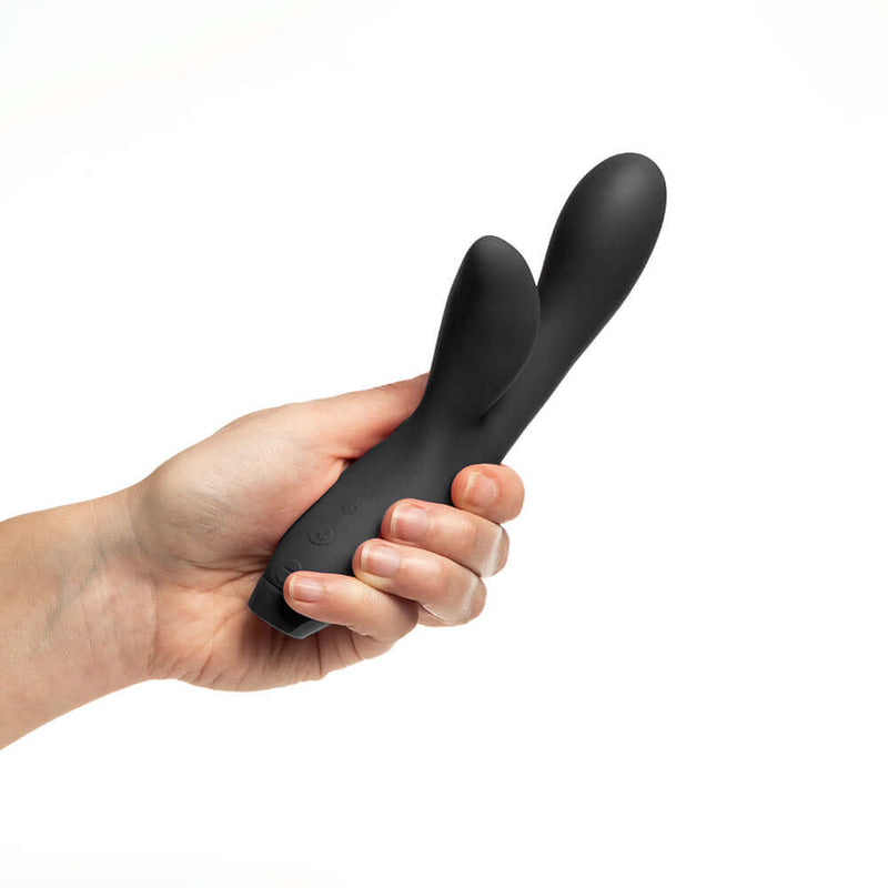 Hand holding the Je Joue Hera Flex Dual Rabbit Vibrator Black, showcasing its sleek design and dual action features.