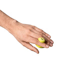 Dame Fin 2.0 Finger Vibrator Citrus on a hand, showcasing its ergonomic design and vibrant color.