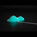 Vibepad Intense Dual Zone Hands Free Vibrator in turquoise color with charging cable against a dark background.