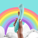 Image of the Biird Gii Glow Vibrator Mint held against a colorful rainbow background.