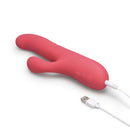 Le Wand Thrust Rabbit Vibrator in pink, showcasing USB charging port and dual stimulation design.