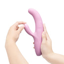 Person holding the Le Wand Hither Rocking Rabbit Vibrator showcasing its ergonomic design and dual-stimulation functionality.