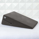 Liberator Ramp Sex Positioning Aid Décor Velvet Black on a bed, enhancing comfort and support during intimate moments.