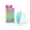 Spectrum Essentials Silicone Compact External Vibrator Blue displayed next to its packaging, showcasing its ergonomic design.