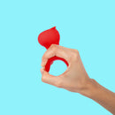Hand holding the Cute Little Fuckers Morrie Mushroom Vibrator Red on a bright background.