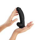 Shaft Model C 7.5 Inch Dong With Balls Black held between two hands, showcasing its design and texture.