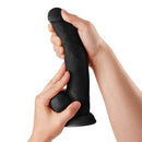Shaft Model C 9.5 inch Liquid Silicone Dong with Balls Black held in hands for realistic feel