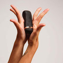 Handy The Oh Vibrator Black held in two hands, showcasing its innovative design and controls.