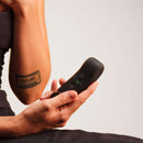 Close-up of a person holding the Handy The Oh Vibrator Black with ResoTouch technology.