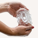 Person holding The Handy TrueGrip Gen 2 Sleeve showcasing its textured design and clear material.