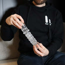 Person holding The Handy Dream Collection Chrysm Sleeve, a clear textured sleeve for anal play.