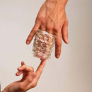 The Handy Mermaid Collection Coral Sleeve held in hand showcasing its texture and design.