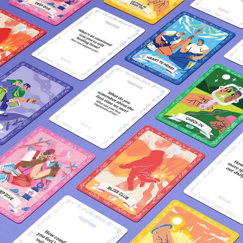 Biird x Jouissance Club Together Couples Card Game showing various colorful conversation cards on a purple background.