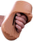 PDX Plus Double Pounder Vibrating Squeeze Stroker Brown in hand, showcasing the soft Fanta Flesh material and design.