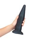 b-Vibe Fisting Anal Trainer in hand, featuring a tapered design for advanced anal training.