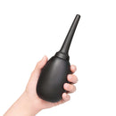 b-Vibe Flexible Silicone Anal Douche Black held in hand, ideal for smooth and efficient cleansing.