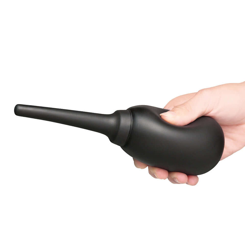 b-Vibe Flexible Silicone Anal Douche Black held in a hand, designed for comfortable and safe hygiene.