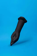 b-Vibe Vibrating Silicone Fisting Dildo shown on blue background, featuring a lifelike hand design and powerful vibration.