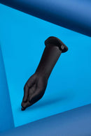 b-Vibe Vibrating Silicone Fisting Dildo on a blue background showcasing its lifelike hand shape and design.