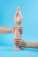 Image showing b-Vibe Silicone Hand Fisting Dildo being held, illustrating its realistic design and function.