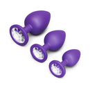 b-Vibe Jewel Butties Bundle featuring three purple silicone anal plugs with jeweled bases.