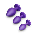 b-Vibe Jewel Butties Bundle three purple body-safe silicone anal plugs in graduated sizes.