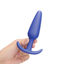 b-Vibe Butties Beginner Booty Bundle blue silicone anal plug held in hand for beginners.