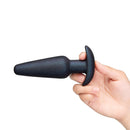 b-Vibe Butties Hefty 5.5 inch Weighted Anal Plug held in a hand, showcasing its sleek silicone design.